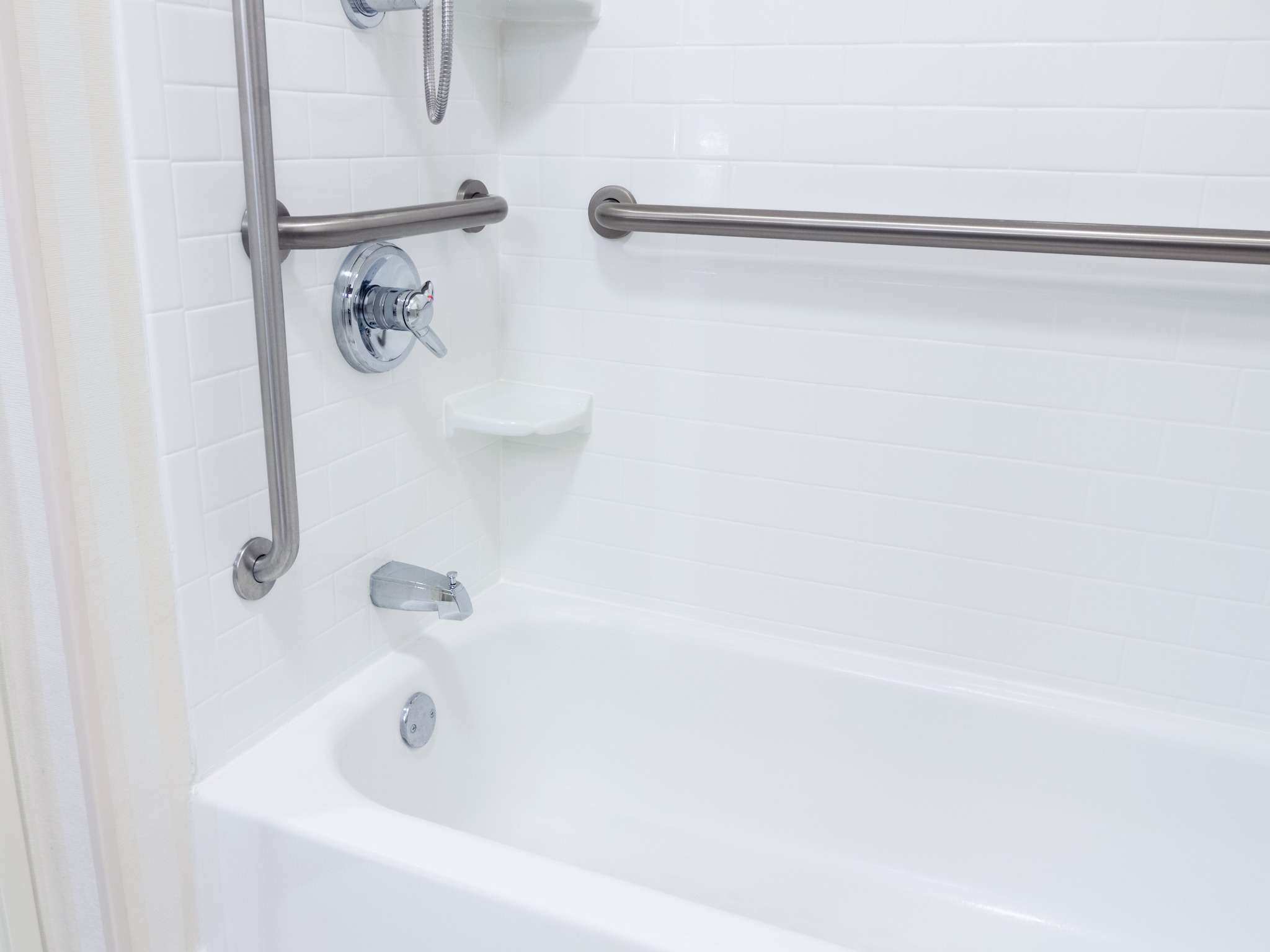 Bathtub and shower fitted with accessibility grab bars