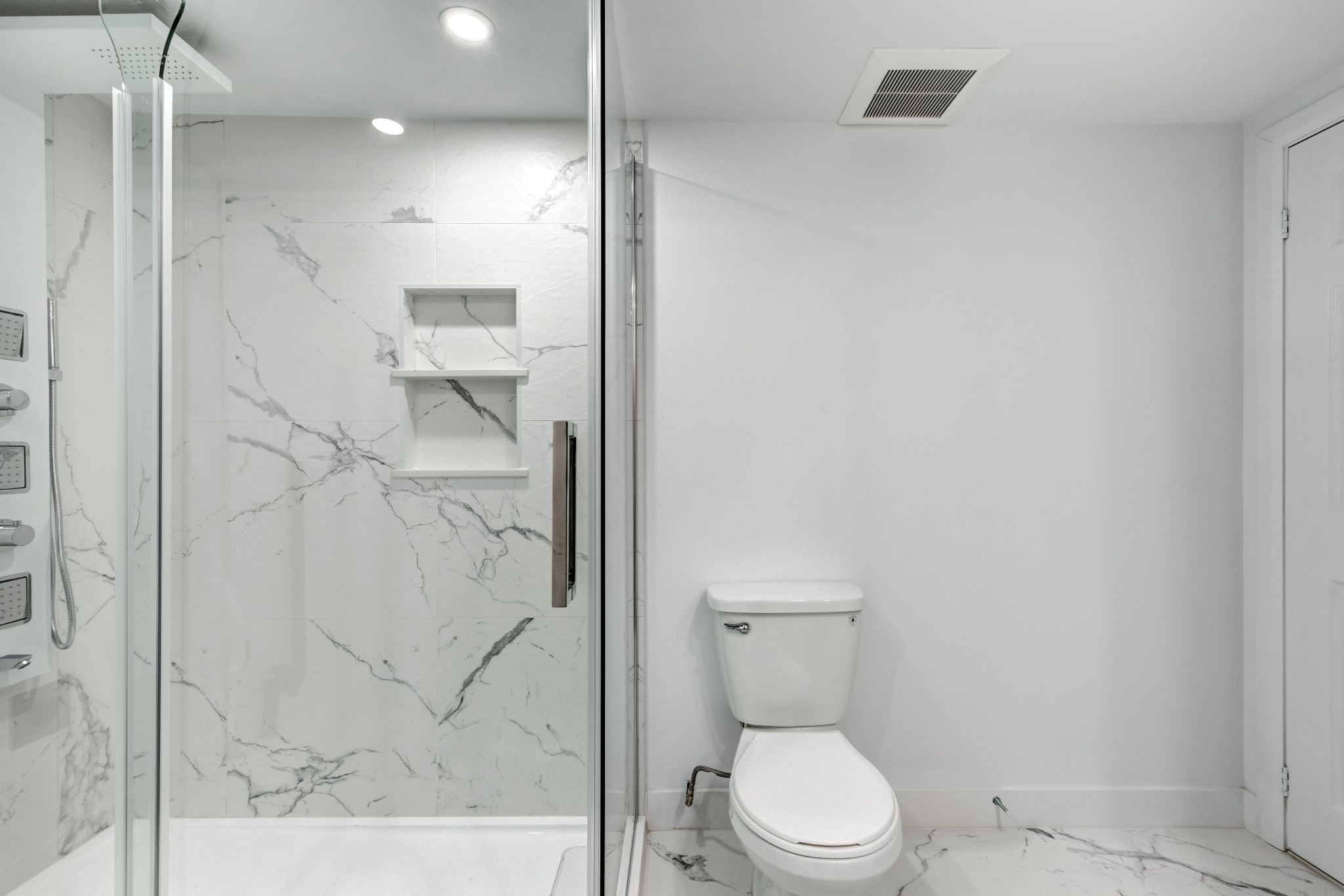 Modern bathroom with marble-look tiled shower